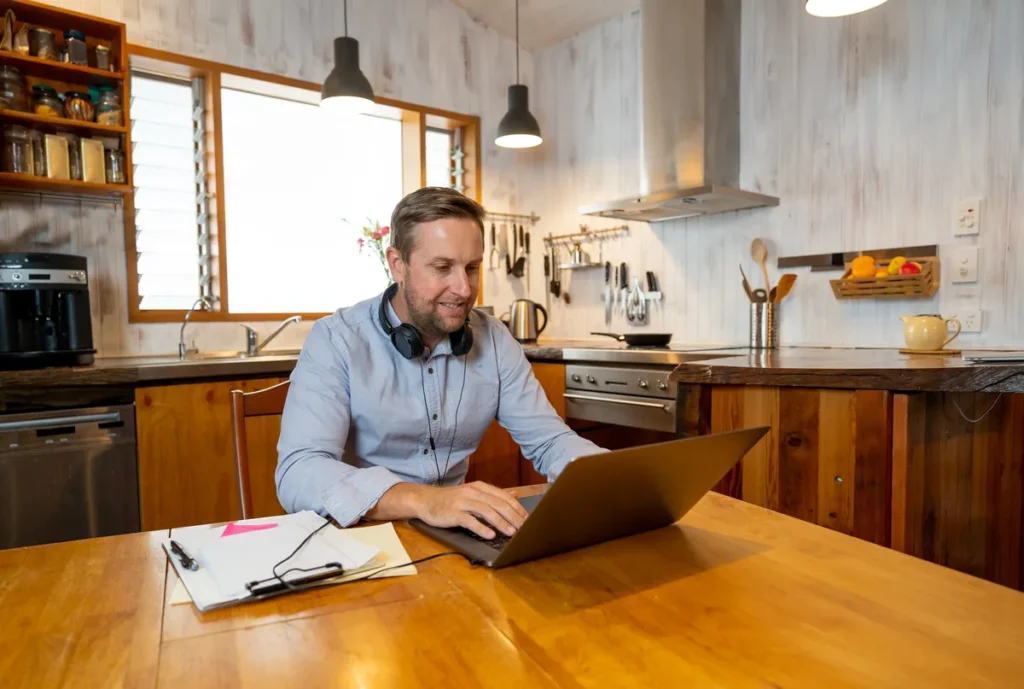 Self-employed man preparing his income documents on a laptop at home