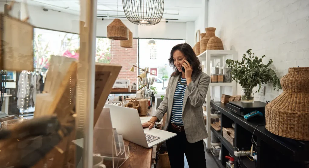Shop owner on the phone in her store talking to a finance broker