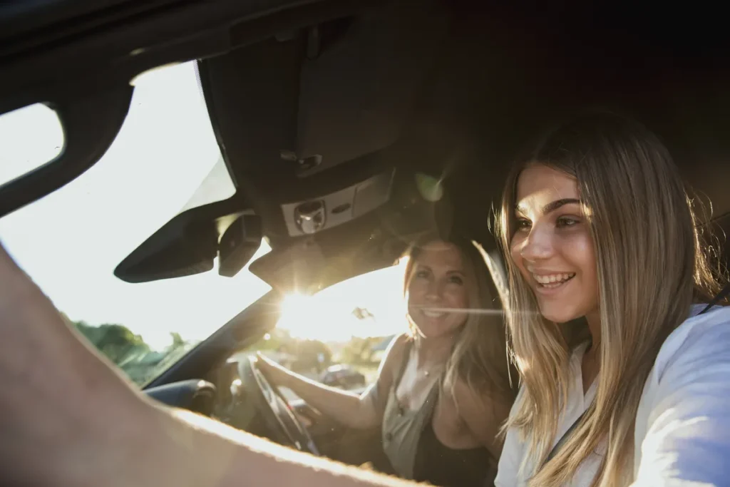 Mother and daughter driving their car
